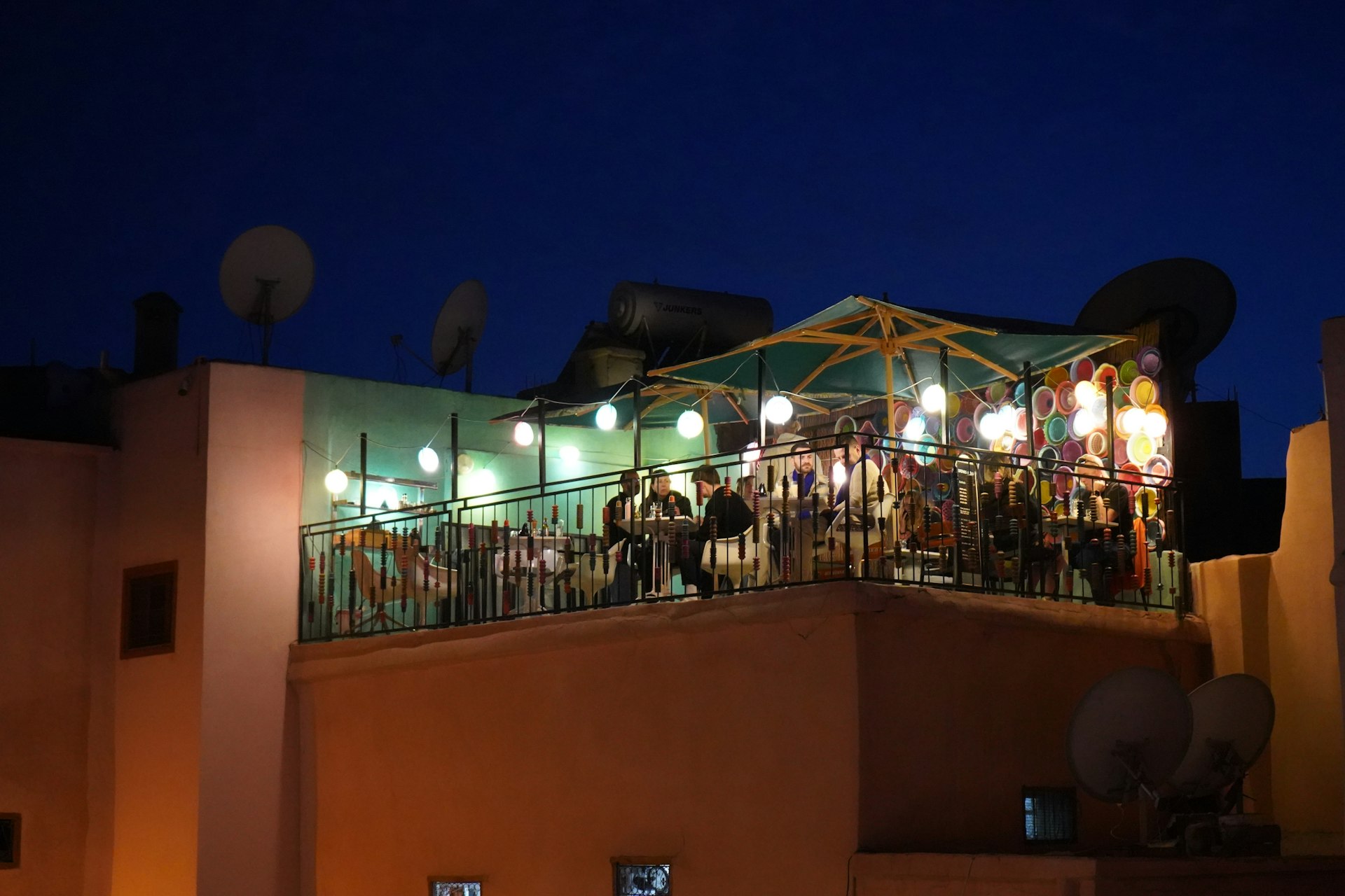 a group of people standing on top of a building